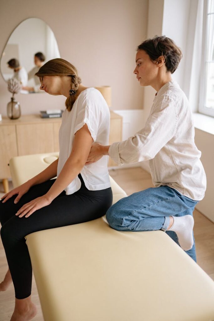 pexels-photo-5793804 Chiropractor giving a spinal adjustment to a female patient in a clinic setting, focusing on back health.