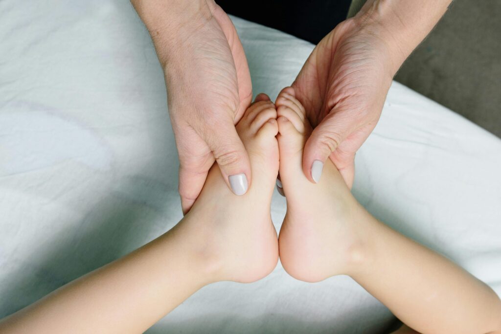 pexels-photo-6340550-6340550 Adult hands gently massaging baby feet. Perfect representation of care and relaxation.