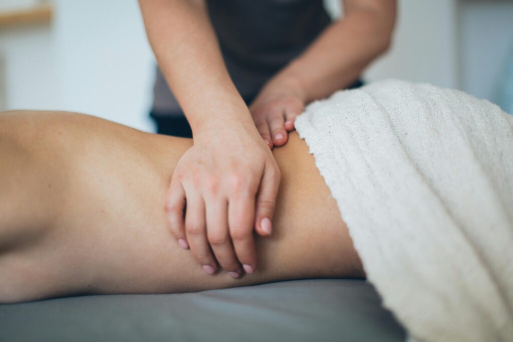 pexels-photo-3865793-3865793 Close-up of a woman receiving a therapeutic massage in a serene spa setting with a white towel.
